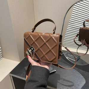Brown quilted leather crossbody bag with gold chain and asymmetrical flap design