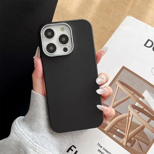 Detail of black lychee leather phone case with silver metal camera ring protection