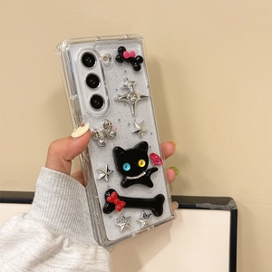Detail of clear Samsung case featuring 3D black cat, star, and bone charms with glitter