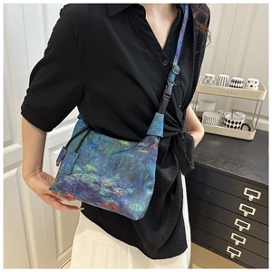 Detail of adjustable floral printed shoulder strap on an artistic cross-body bucket bag