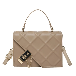 Elegant beige quilted PU leather handbag with metal lock and chain detail on white background