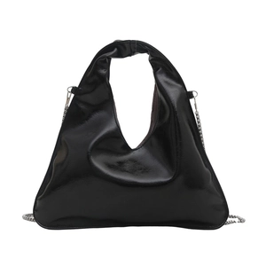 Glossy black triangular bucket bag in patent leather with a silver chain strap