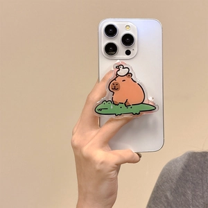 Close-up of acrylic Capybara and duck phone griptok holder on a white smartphone