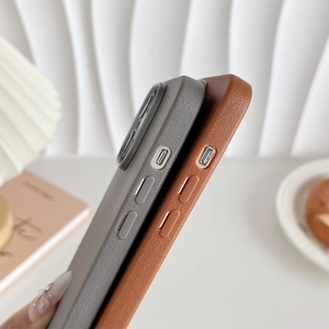 Detail of dark grey and brown faux leather cases with metallic buttons for iPhone
