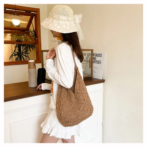 Detail of a brown hand-woven crochet tote bag with hollow diamond knit patterns