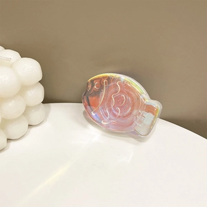 Macro view of fish-shaped holographic phone grip with iridescent laser finish effect