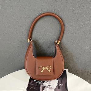 Retro brown hobo shoulder bag with a gold bow accent and Saffiano faux leather finish
