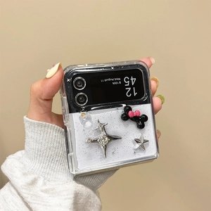 Close-up of clear Z Flip case with silver stars, black bow, and diamond accents