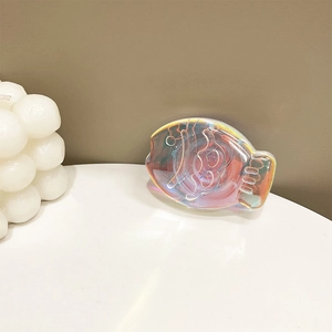 Detailed view of fish-shaped holographic phone grip with iridescent gradient texture