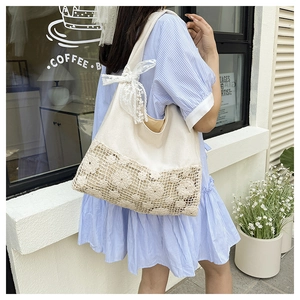 Close-up detail of a hollow floral canvas shoulder bag featuring a white lace bow.