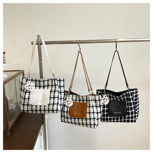 Detailed trio of tweed tote bags in white and black with leather pockets and tiger charms