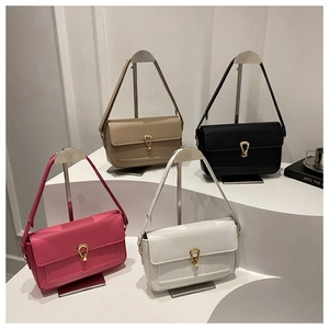 Detail view showing beige, black, pink and white crossbody bags with horseshoe metal buckles
