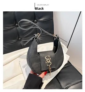 Detalle del bolso hobo de cuero PU negro con cierre en S dorado y colgante de borlas