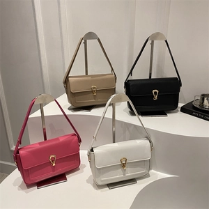 Litchi texture leather tote bags in four colors with gold horseshoe buckles on white stand