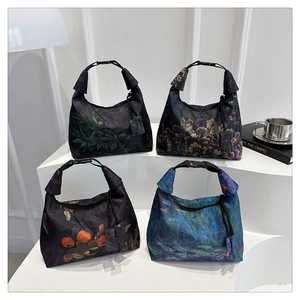 Detailed set of four printed handbags featuring artistic floral and botanical patterns