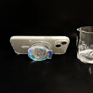 Macro detail of a fish-shaped holographic resin phone grip with blue gradient glitter