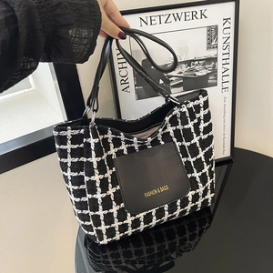 Chic black and white tweed tote bag with leather pocket and gold fashion logo