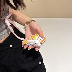 Detail of transparent AirPods case featuring 3D miniature croissants and bread charms