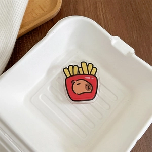 Detail of red French fries box capybara phone grip holder made of clear acrylic