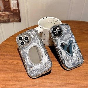Silver liquid metal iPhone case with heart mirror and rhinestones on wooden background