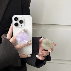 Detail of 3D cat paw phone grip with glossy resin texture in purple and green