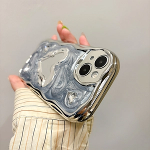Macro shot of silver plated wave frame and blue marble heart mirror on phone case