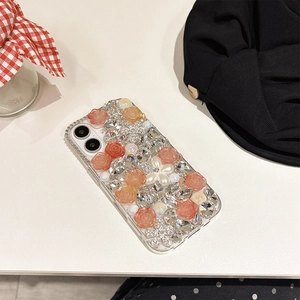 Detailed view of luxury iPhone case with pink resin roses, pearls, and rhinestones decoration