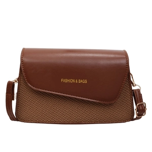Chic two-tone brown crossbody bag with smooth leather and textured fabric detail