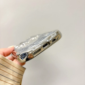 Close-up of precise speaker and charging port cutouts on silver mirror iPhone case