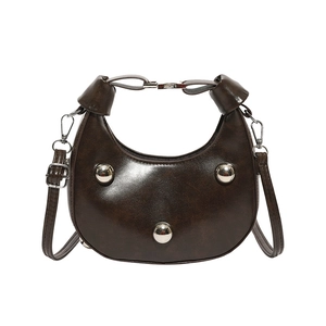 Deep brown crescent shoulder bag with polished oil-wax finish and silver stud details