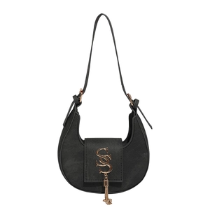 Chic black crescent underarm bag with gold S-logo and metal tassel on white background