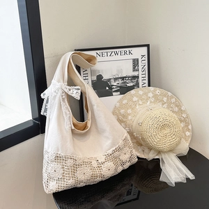 Korean style canvas hobo bag featuring hollow flower crochet and a delicate lace bow