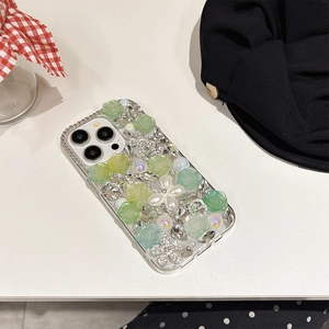 Close-up of luxury iPhone case with 3D green roses, white pearls and sparkling rhinestones