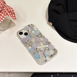 Detailed view of luxury iPhone case with 3D resin roses pearls and rhinestones