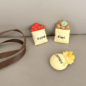 Close-up of cute fruit bag phone grips featuring apple kiwi and lemon miniature designs