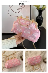 Detail of pink mesh evening bag with white sequins, metal ring handle and gold chain