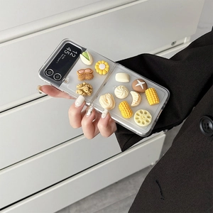 Detail of Galaxy Z Flip case featuring realistic 3D food resin charms like walnuts and corn