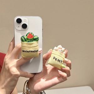 3D fruit bag phone stand with watermelon and peach designs on a handheld mobile case