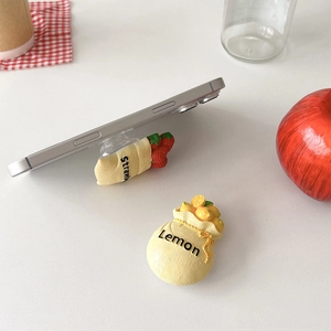 Detail of cute fruit bag phone socket featuring 3D strawberry and lemon textures