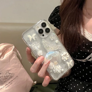 Elegant iPhone case featuring 3D pearlescent butterflies, white flowers, and pearls