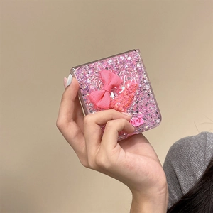 Detail of pink glitter Z Flip case with 3D heart glitter sand and fabric bow