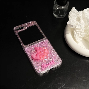 Detailed view of pink glitter phone case with satin bow and Sweet letter decor