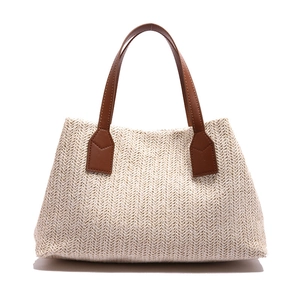 Elegant handmade woven straw tote bag with brown leather handles for casual spring style