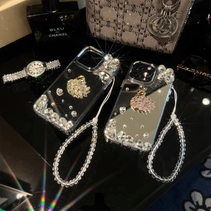 Detailed view of luxury rhinestone swan phone case with bead chain strap for iPhone models