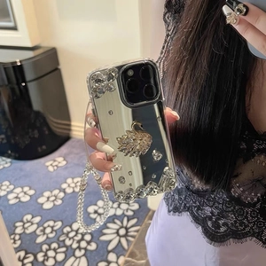 Mirror iPhone case featuring rhinestone swan decor and a clear beaded hand strap
