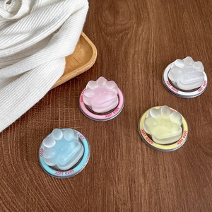 Detailed view of four colorful cat paw phone sockets with Good Luck text on wood