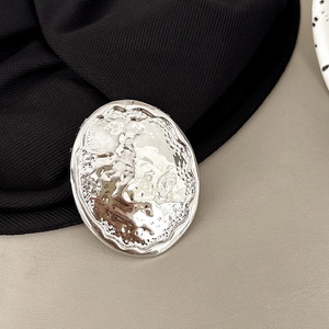 Close-up of silver oval phone socket holder with creative metallic tin-foil texture design
