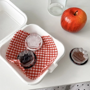 Detailed view of pink cat paw phone socket stand in creative bento-style box packaging