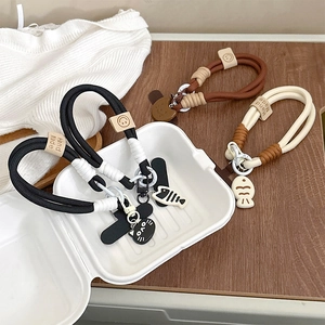 Handmade woven cat and fish bone phone charms in black, brown and cream white