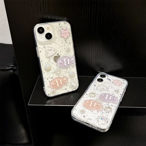 Macro detail of glitter iPhone case featuring 3D resin fish, shells and pearl ornaments